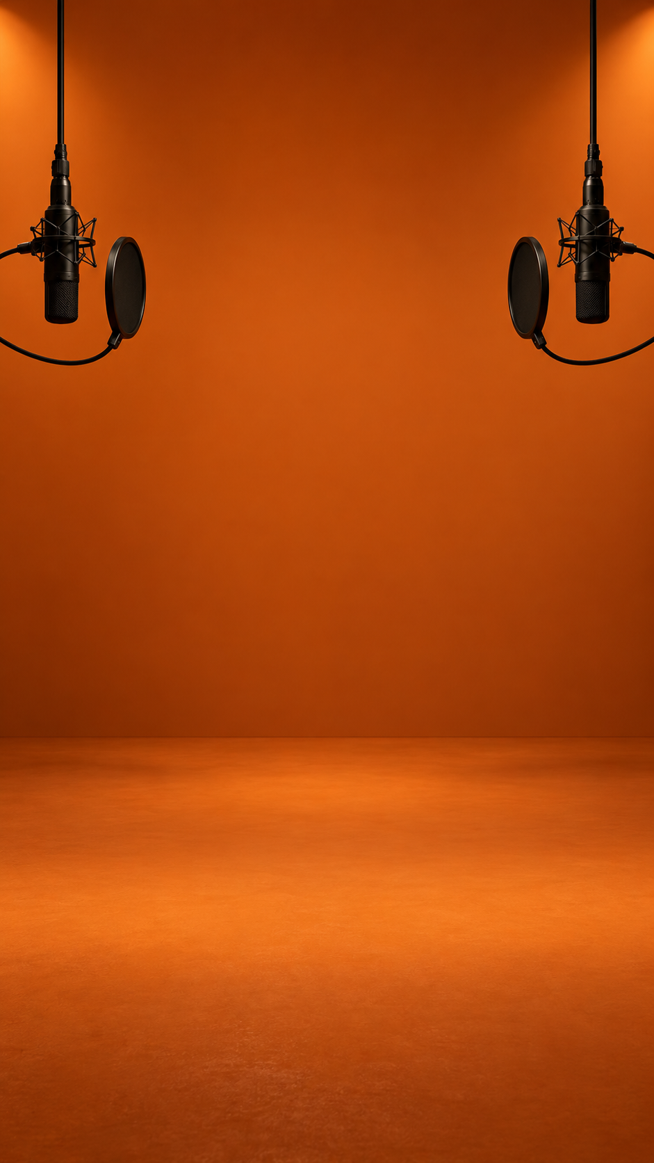Empty orange studio with two hanging microphones